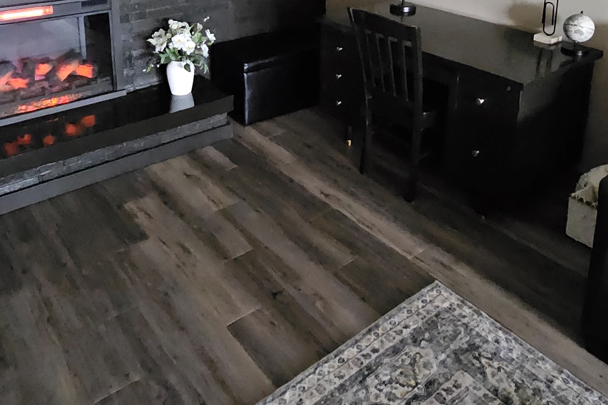 Desk in living room near cozy fireplace