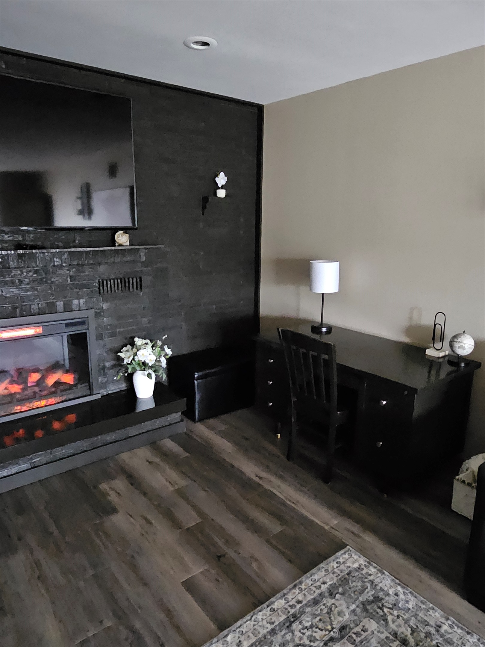 Desk in living room near cozy fireplace