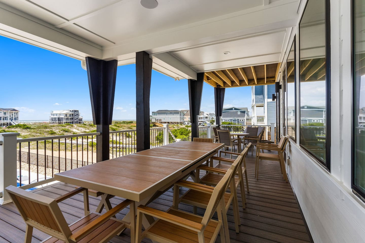 Indoor-outdoor living at its finest. Just off the living room, this expansive oceanfront deck overlooks the private pool and beach, offering the perfect space to relax, dine, and soak in the views.