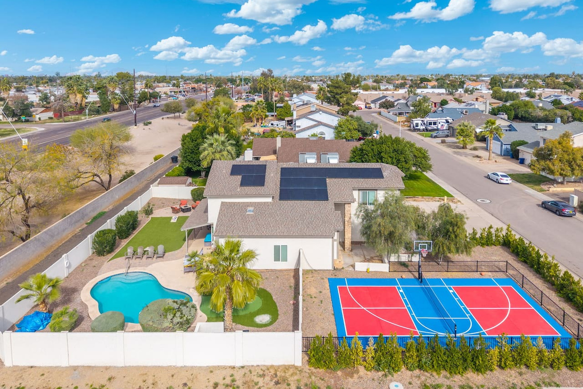 Luxury estate with resort pool, sports courts, solar panels, and sprawling grounds—the ultimate group retreat.