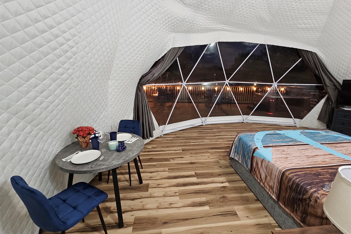 Intimate dining for two with a stunning nighttime view of the glowing deck and lakeside backdrop