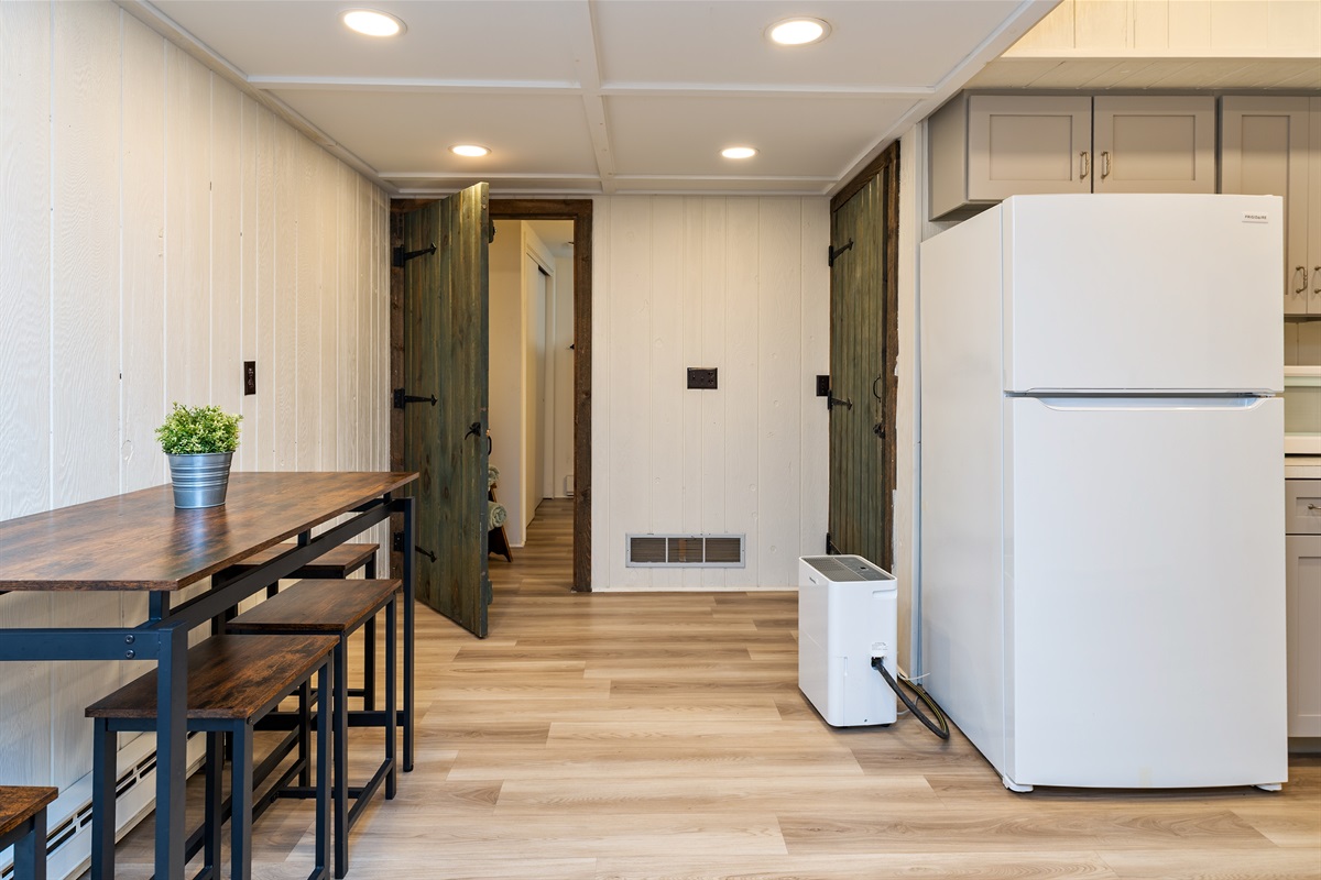 Gather around the cozy dining nook with rustic wood finishes – ideal for quick bites or game-night snacks. Located in the basement.