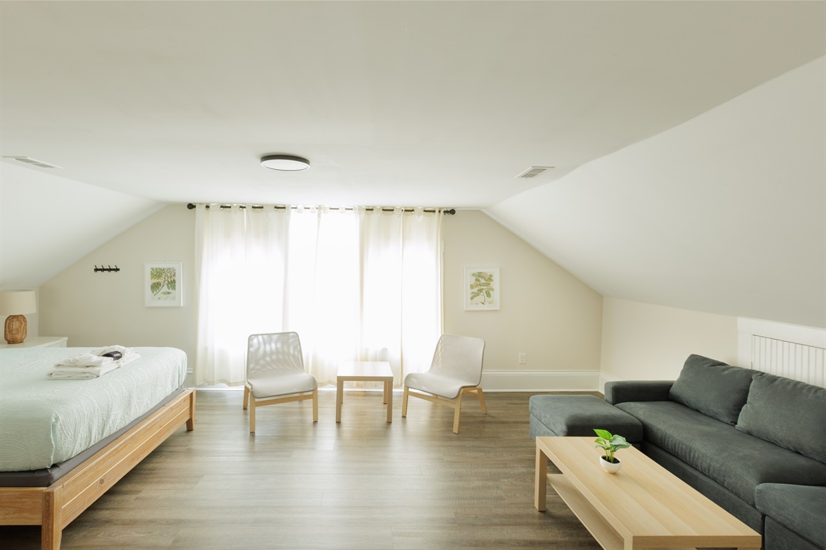 Large Queen Bedroom with additional living area and TV.