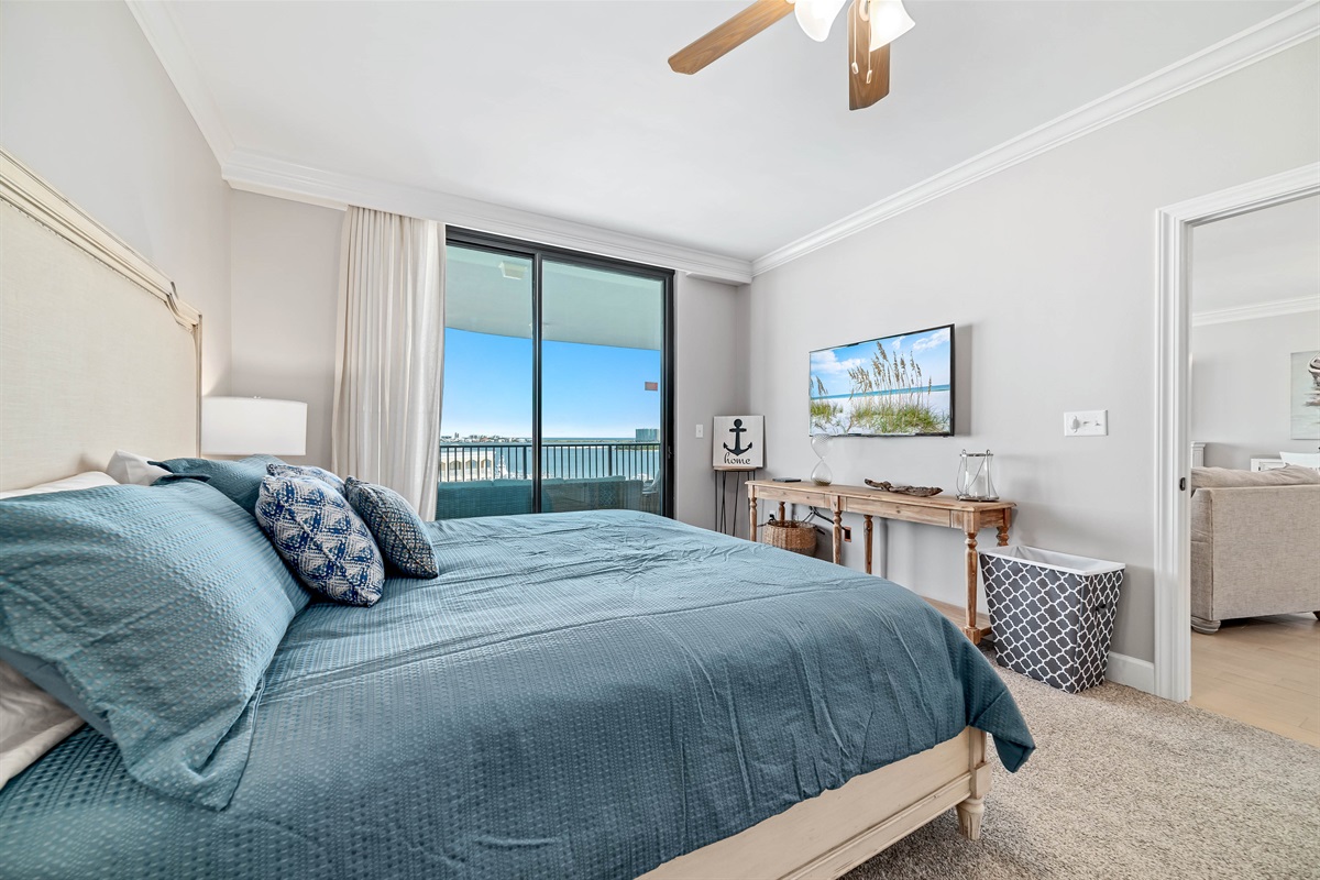Enjoy the perfect blend of comfort and coastal beauty in this inviting bedroom with direct balcony access and stunning ocean views.