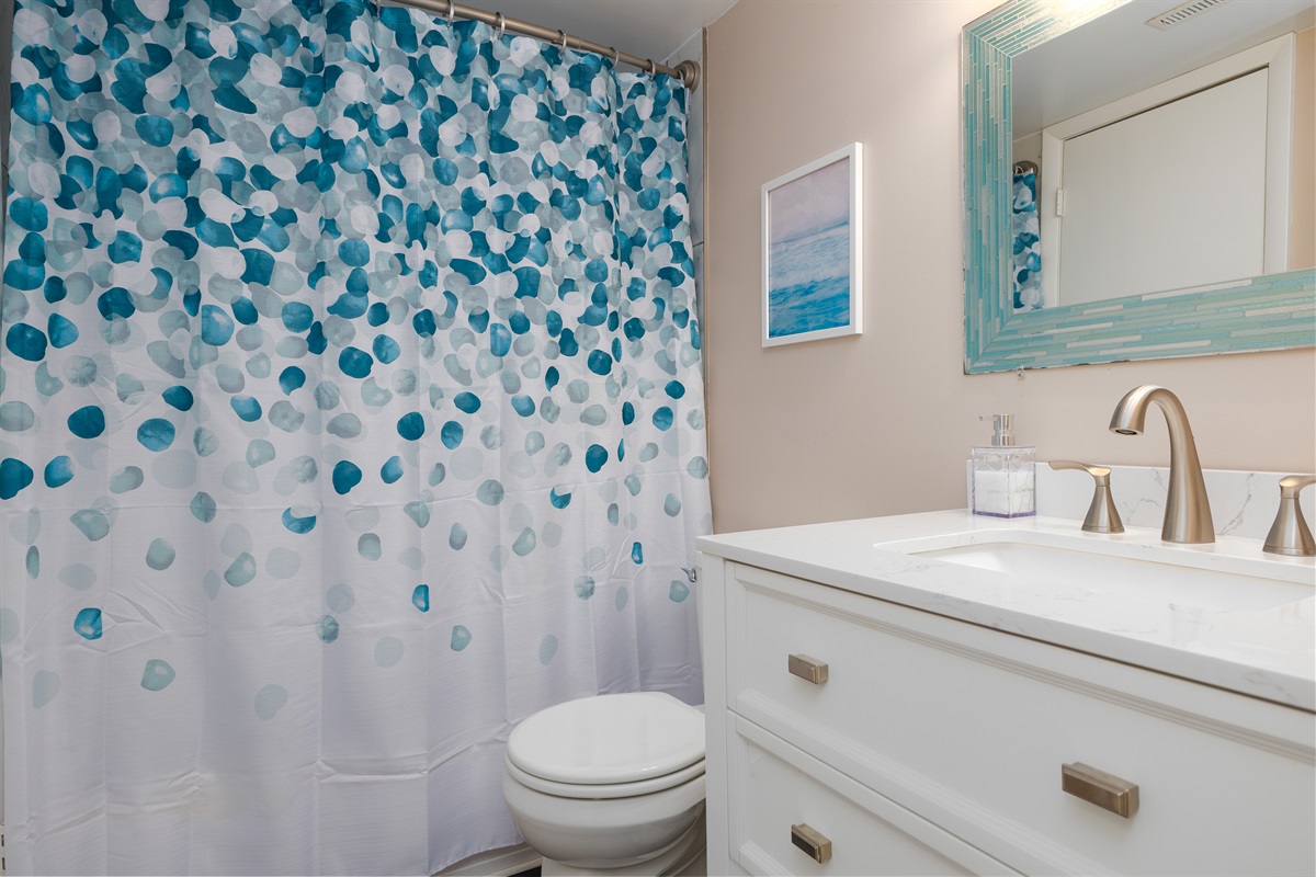 White vanity and coastal-themed decor
