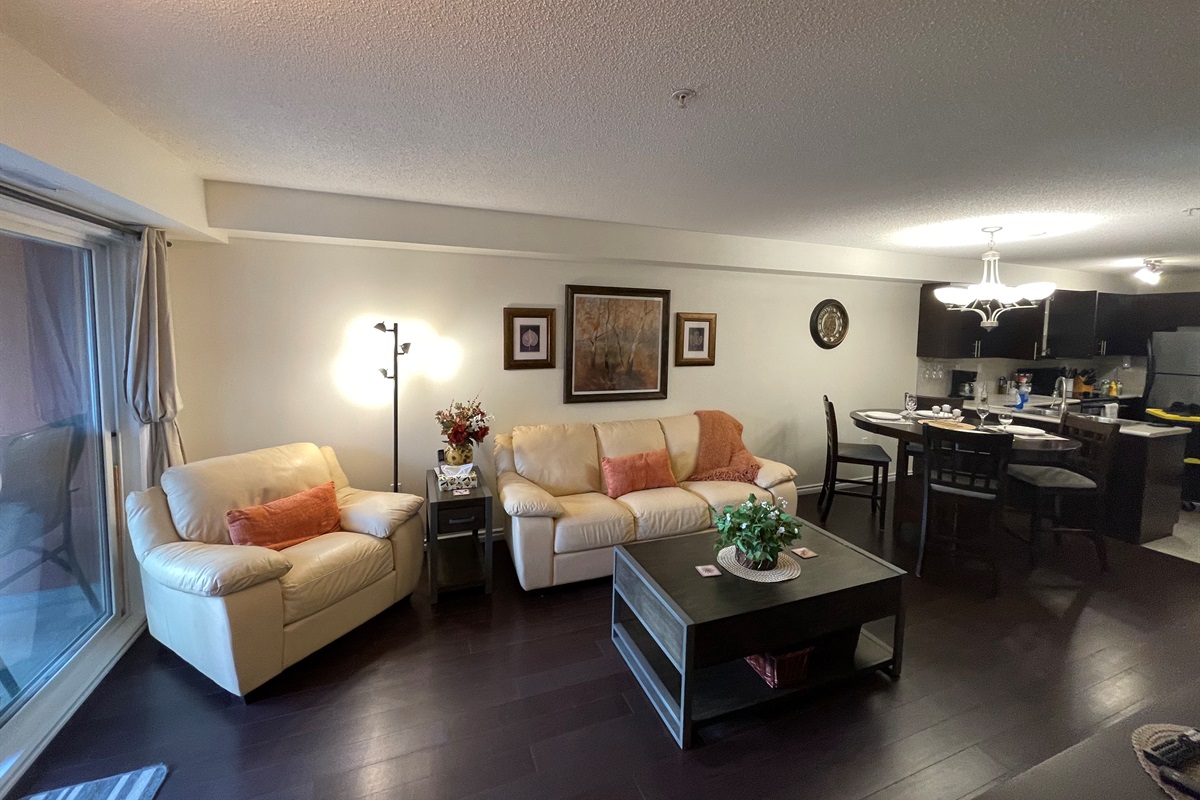 Cozy couch and open concept dining room.