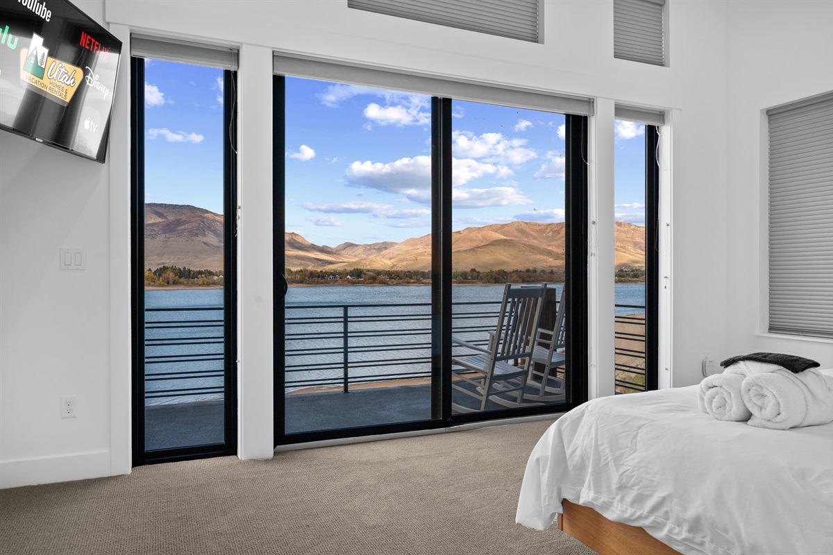King bedroom with walk-out balcony and stunning views of Pineview Reservoir.