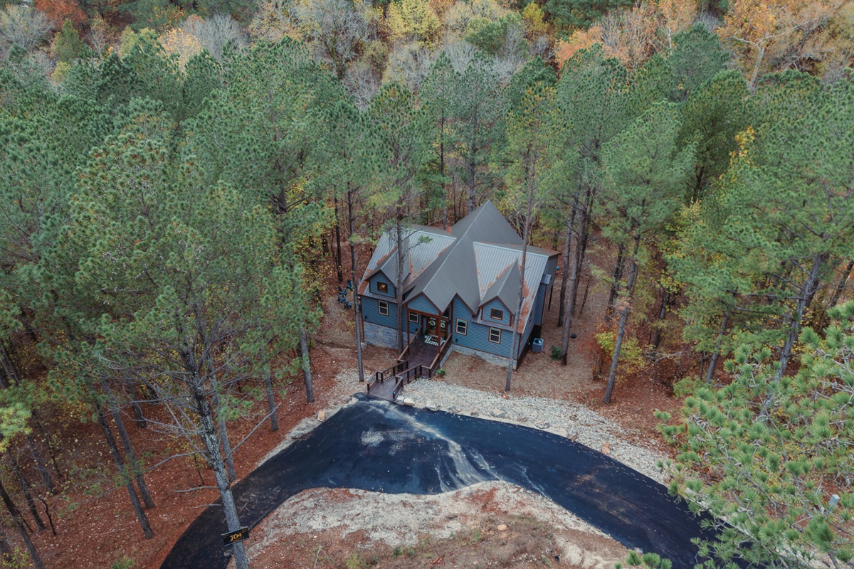 Cute cabin nestled in the woods.
