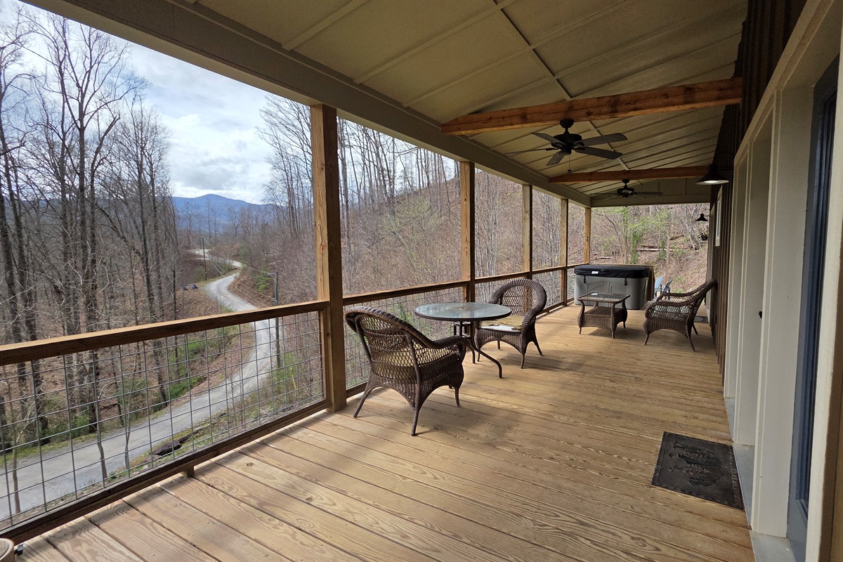 Extra large covered porch with ceiling fans and a hot tub. Great place to relax on a rainy day.