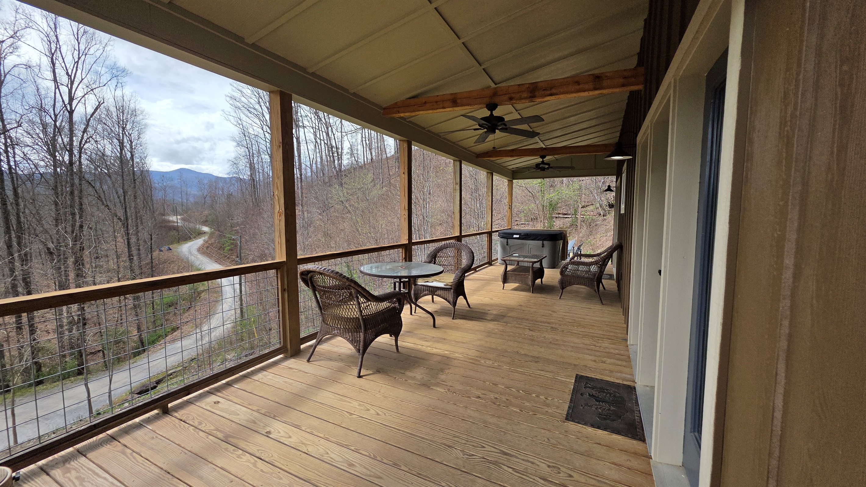 Extra large covered porch with ceiling fans and a hot tub. Great place to relax on a rainy day.