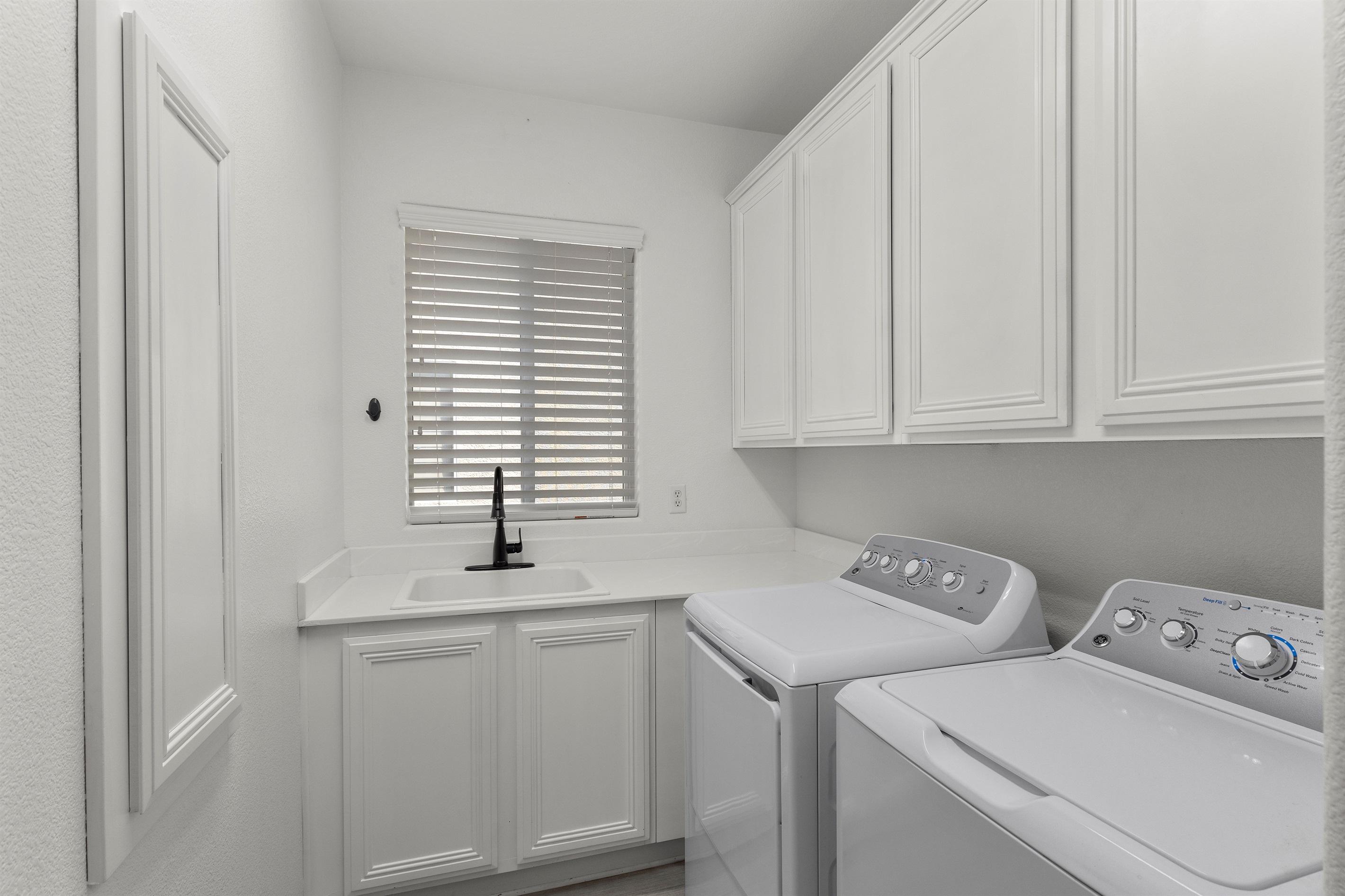 Laundry room with a utility sink and a washer and dryer.  Free of charge to use.  It's Showtime!