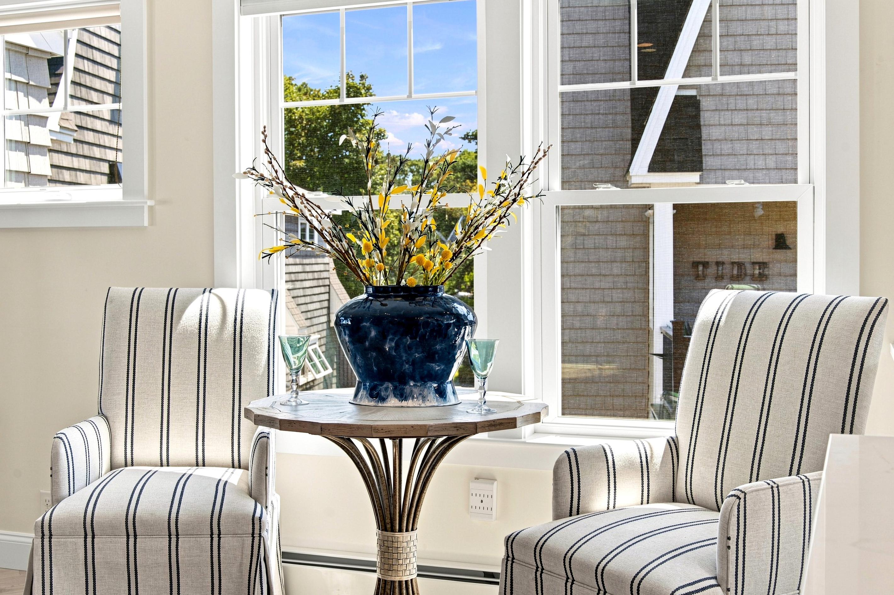 A charming sunlit sitting nook offers a peaceful spot for morning coffee or a quiet moment between beach adventures.