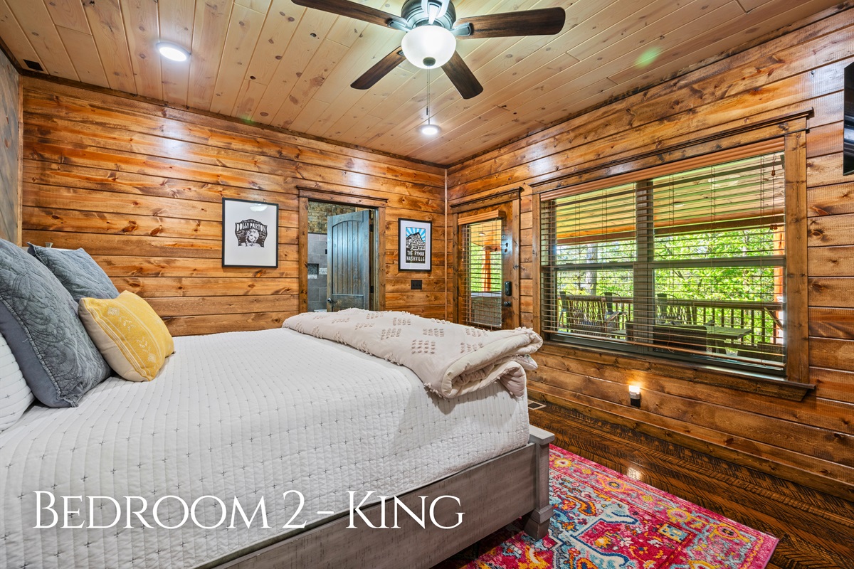 This cozy king bedroom is tucked away for a quiet night’s rest, complete with soft lighting and comfortable furnishings.