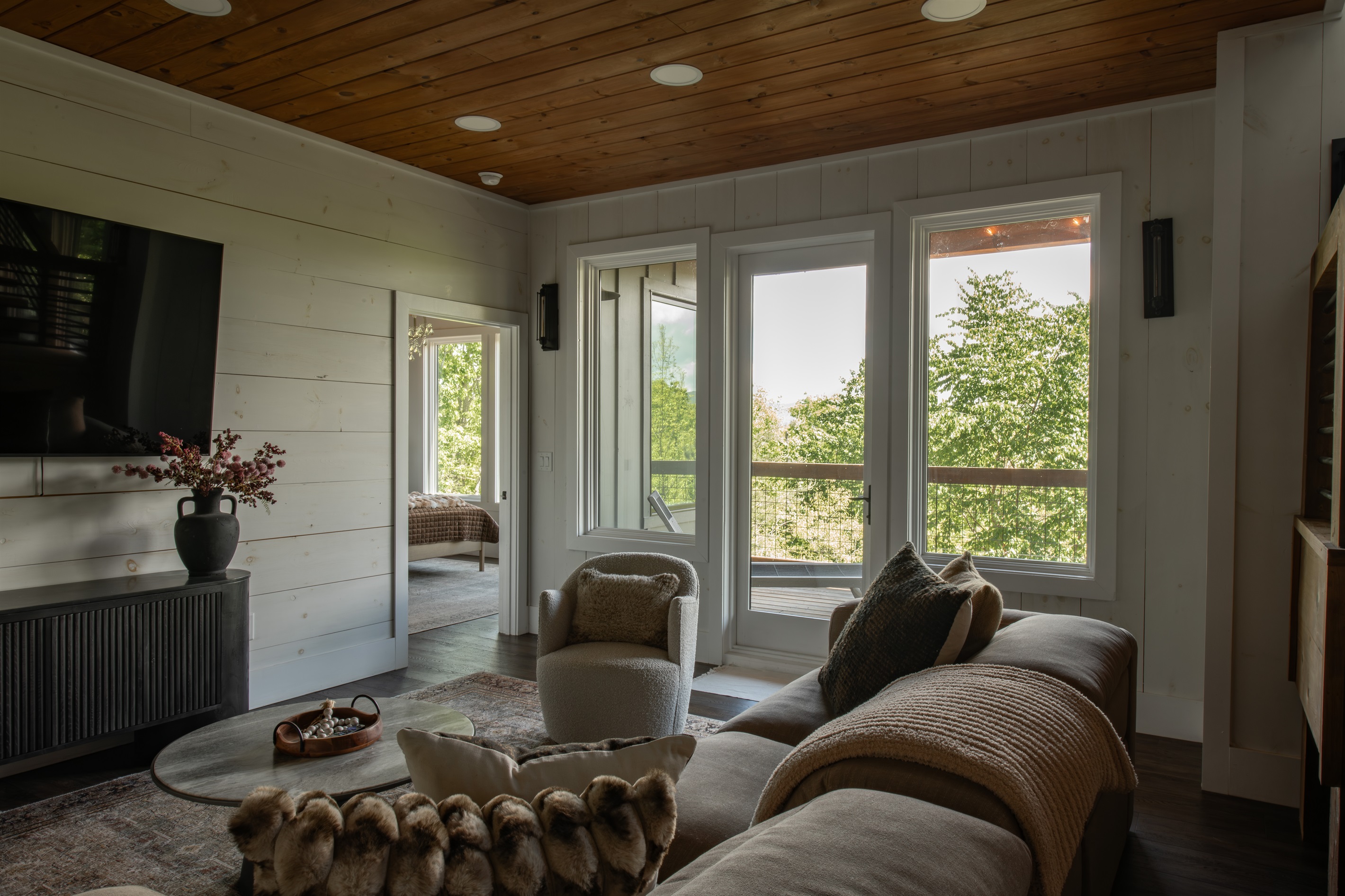 Lower Lounge | Cozy, elevated retreat with plush seating and warm wood finishes