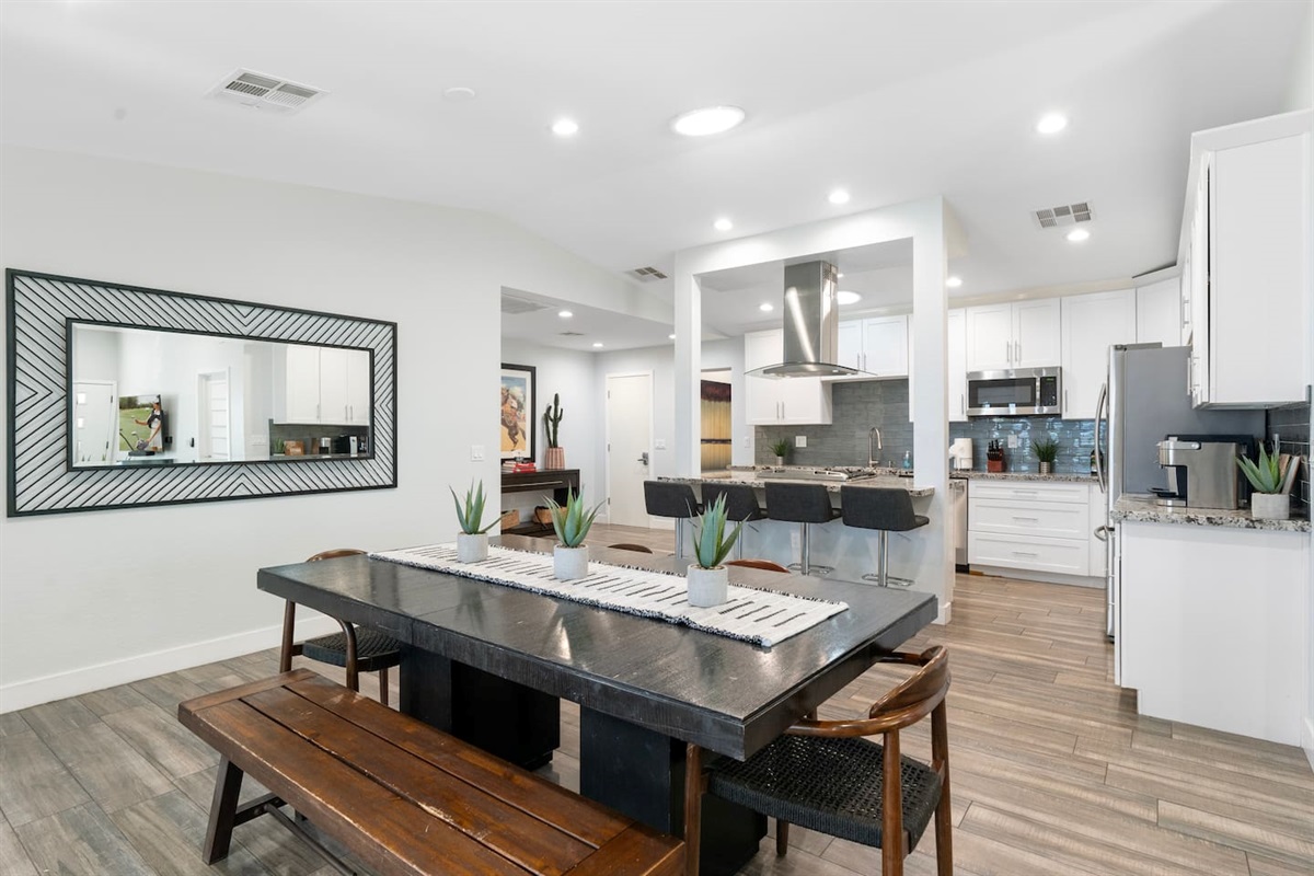 Dining table with a clear view of the open kitchen, creating a seamless and inviting space for meals and entertaining.