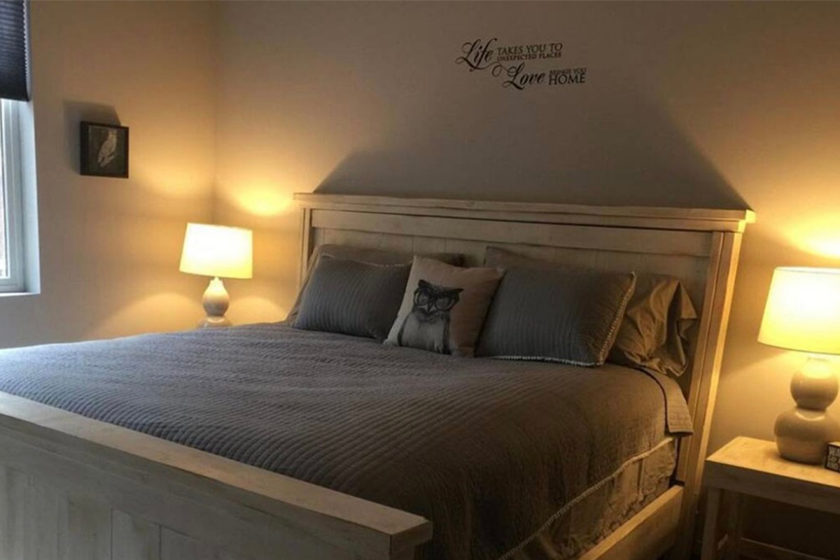Quiet bedroom retreat with warm lighting and comfortable bedding.