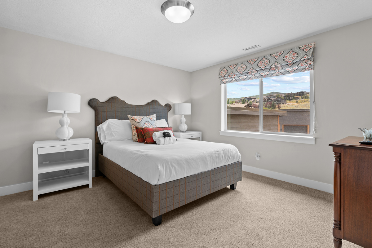 Comfortable upstairs bedroom with a queen bed and mountain views.