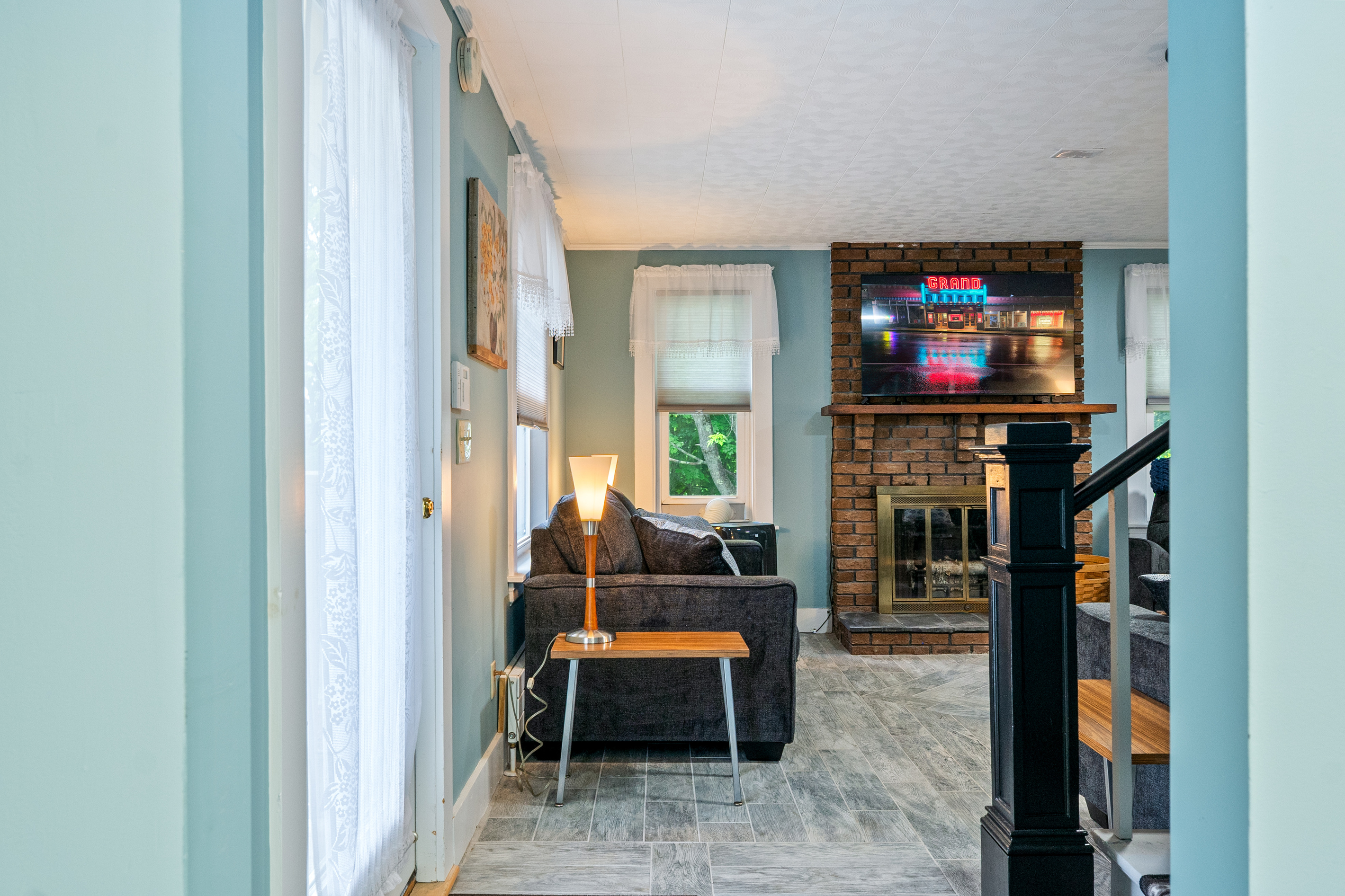 Stay part of the conversation even when stepping away. This view looking out from the quiet compass den shows the direct open connection to the main living room, making it easy to check in on the group while enjoying your own private space.