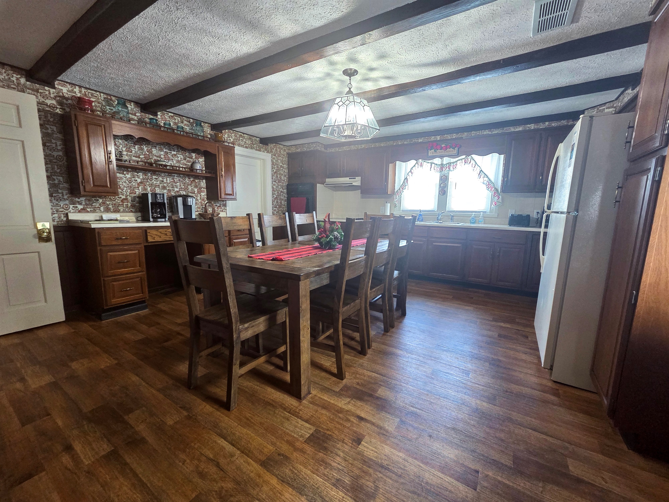 The farmhouse kitchen is warm and inviting, with plenty of room for gatherings, meal prep, and making memories