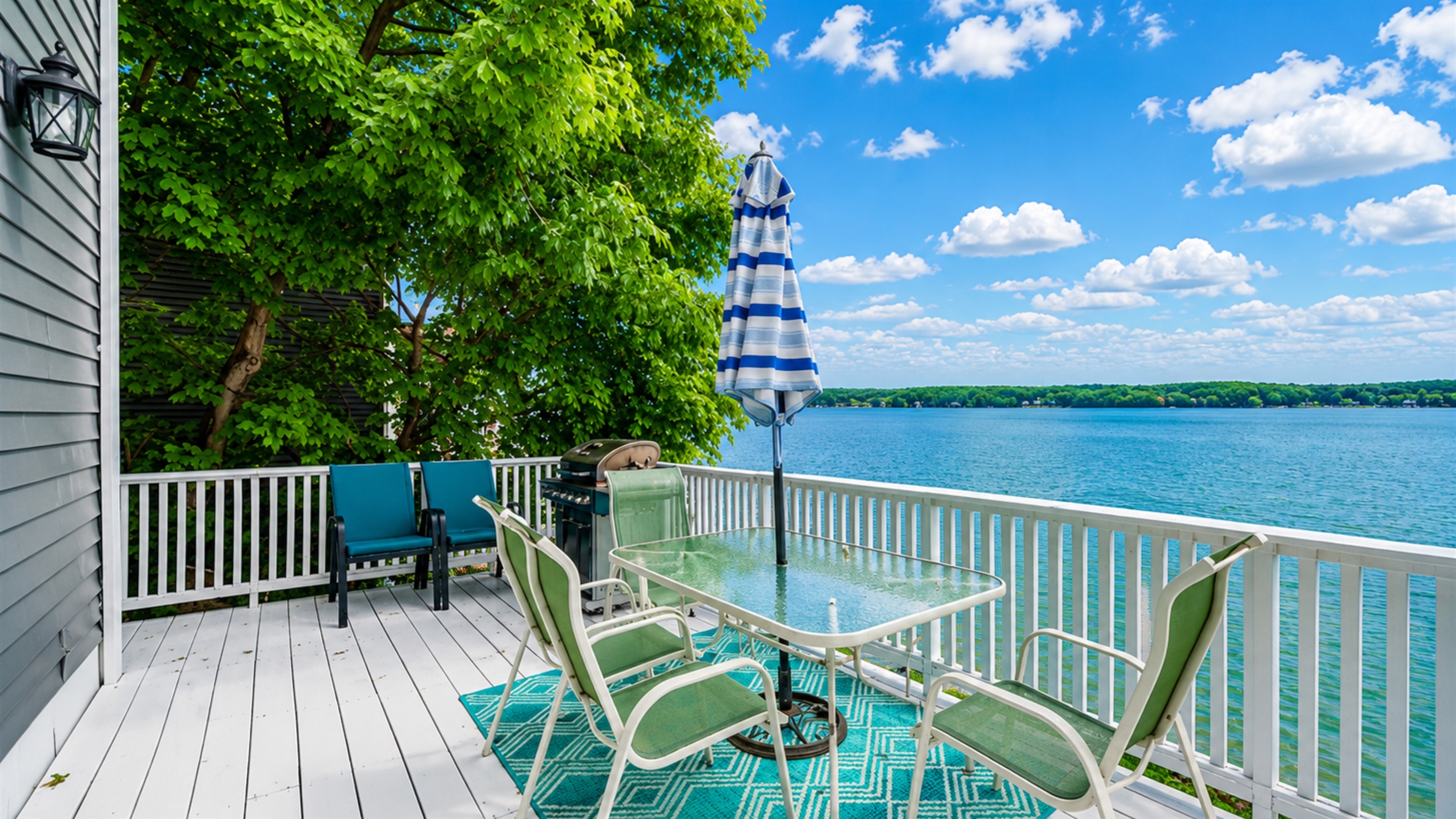 Expansive lakefront deck with stunning views, perfect for morning coffee