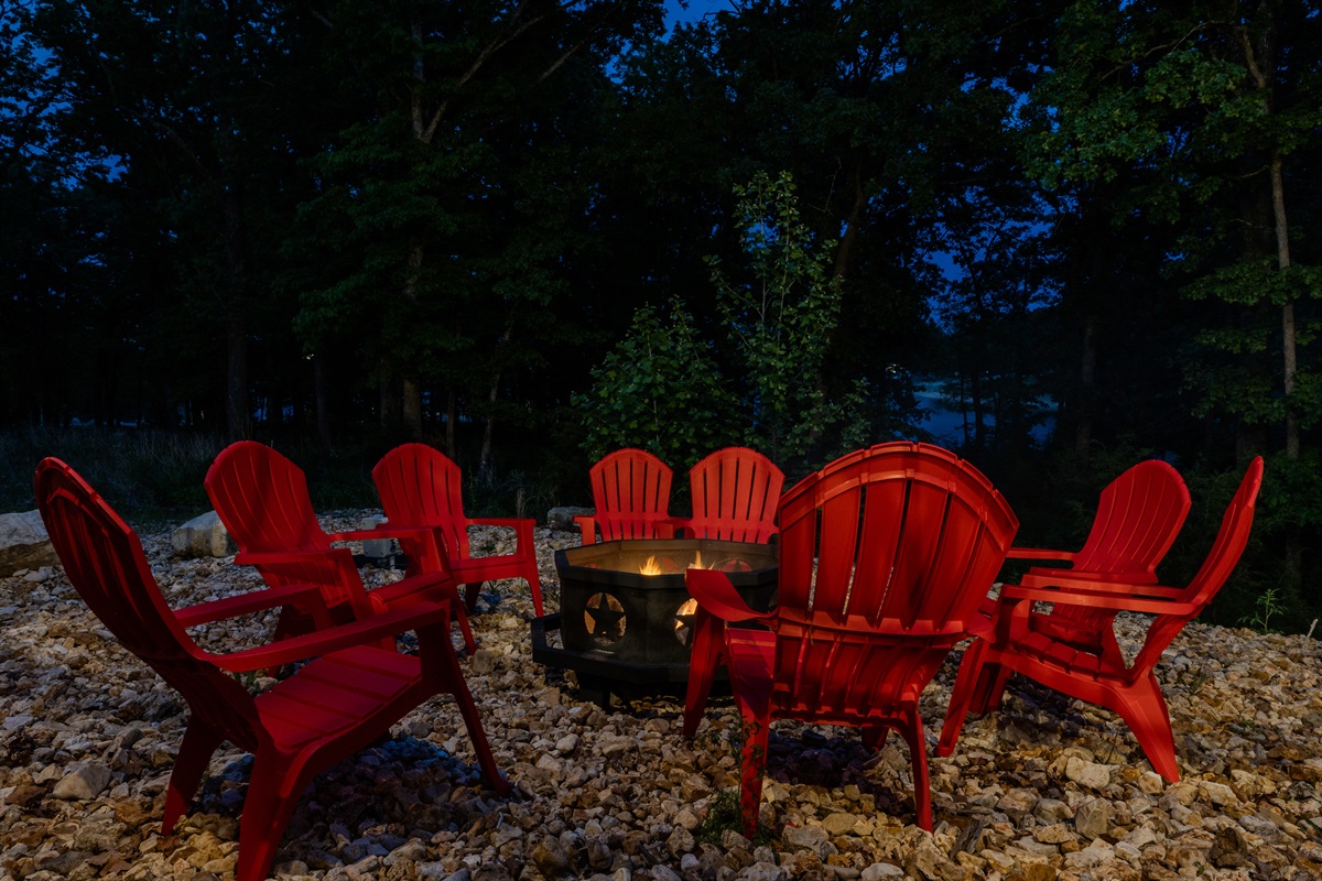 Outdoor fire pit seating area at night
