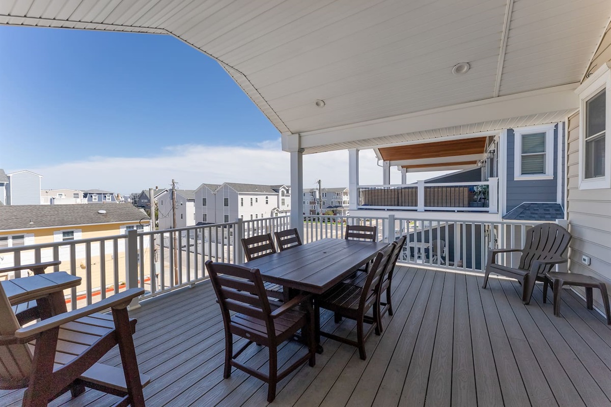Private covered deck for dining and entertaining off the main living room on the top floor with spectacular ocean views. 