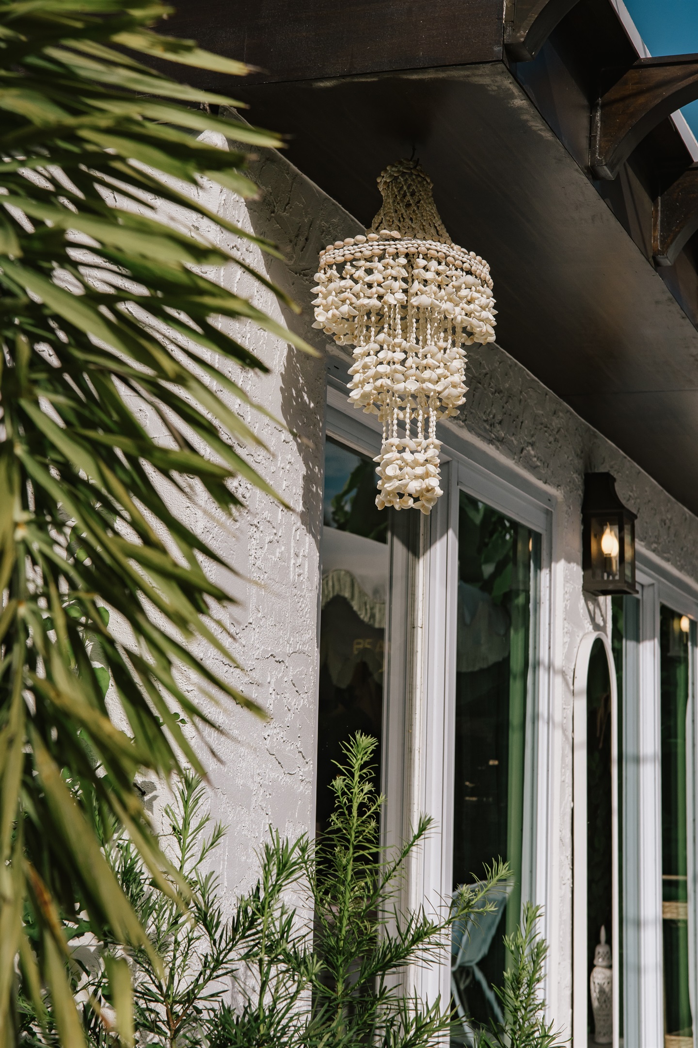 The expansive windows in the rear of the main house simultaneously lets in plenty of natural light while giving an expansive view of the lush garden and patio.