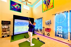 Expansive indoor golf simulator area with a basketball hoop, offering fun and versatility for all your favorite activities