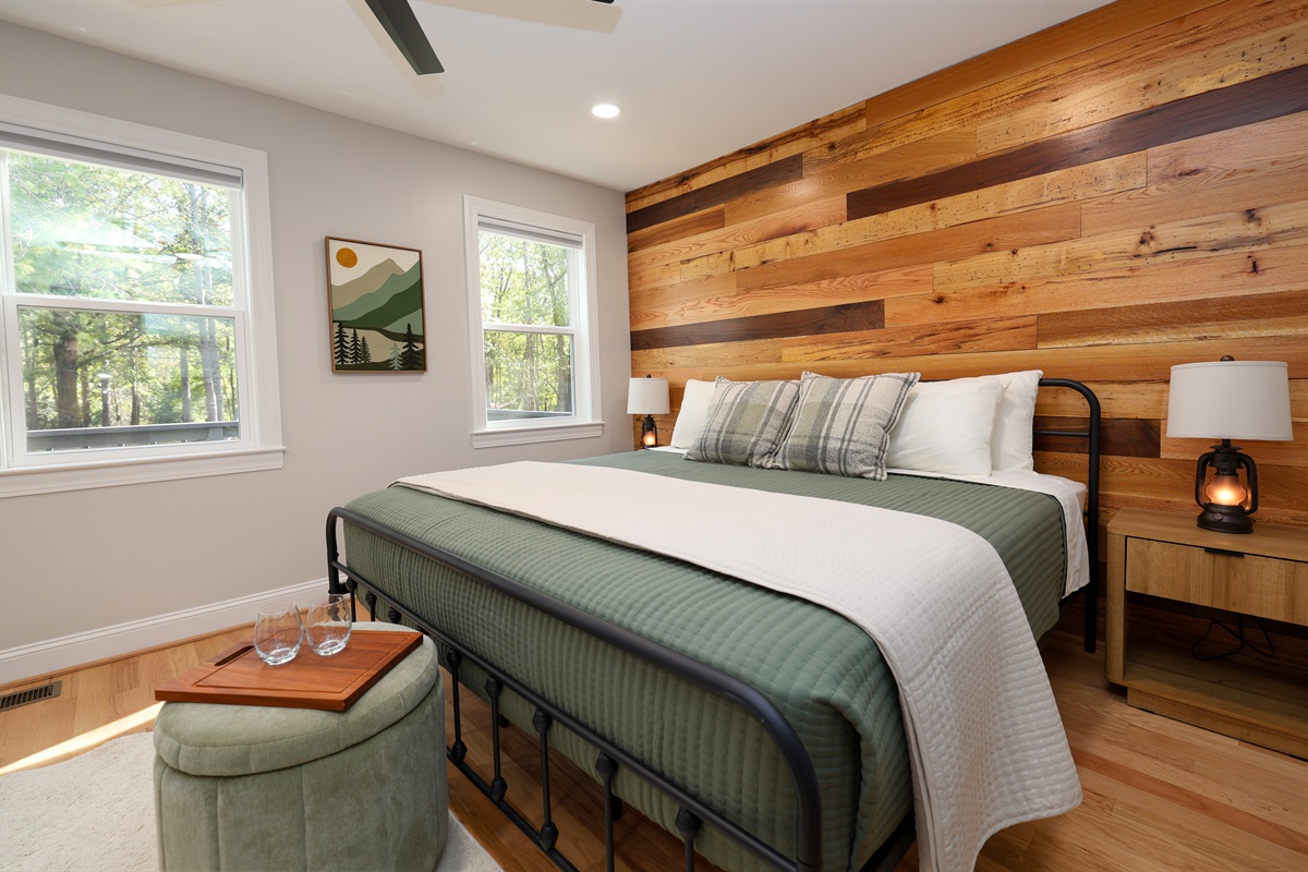 primary bedroom with a view towards the river and expansive backyard