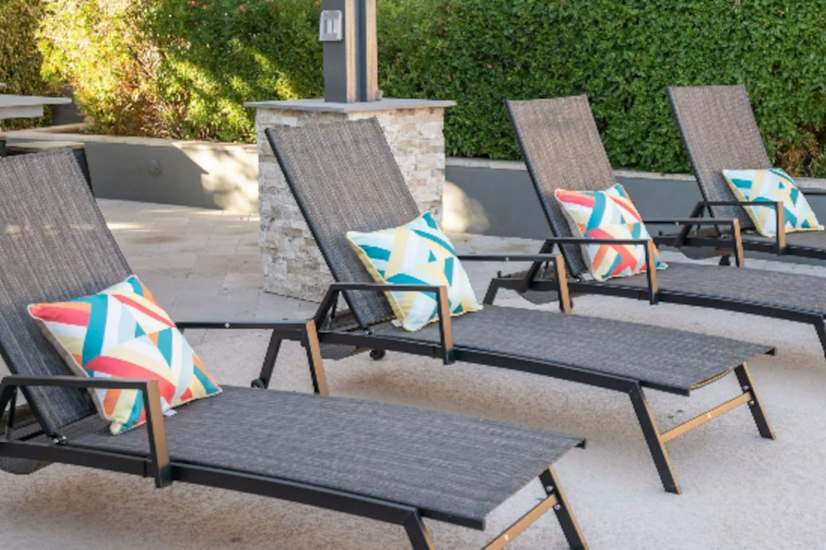 Poolside loungers with colorful throw pillows make for the perfect spot to soak up the Arizona sun.