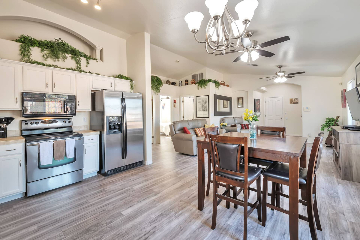 Cook like you're home — a full kitchen with stainless steel appliances, open to the dining and living areas