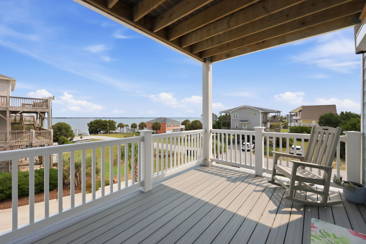 Covered outdoor deck area with comfortable seating and peaceful views of the surrounding coastal landscape