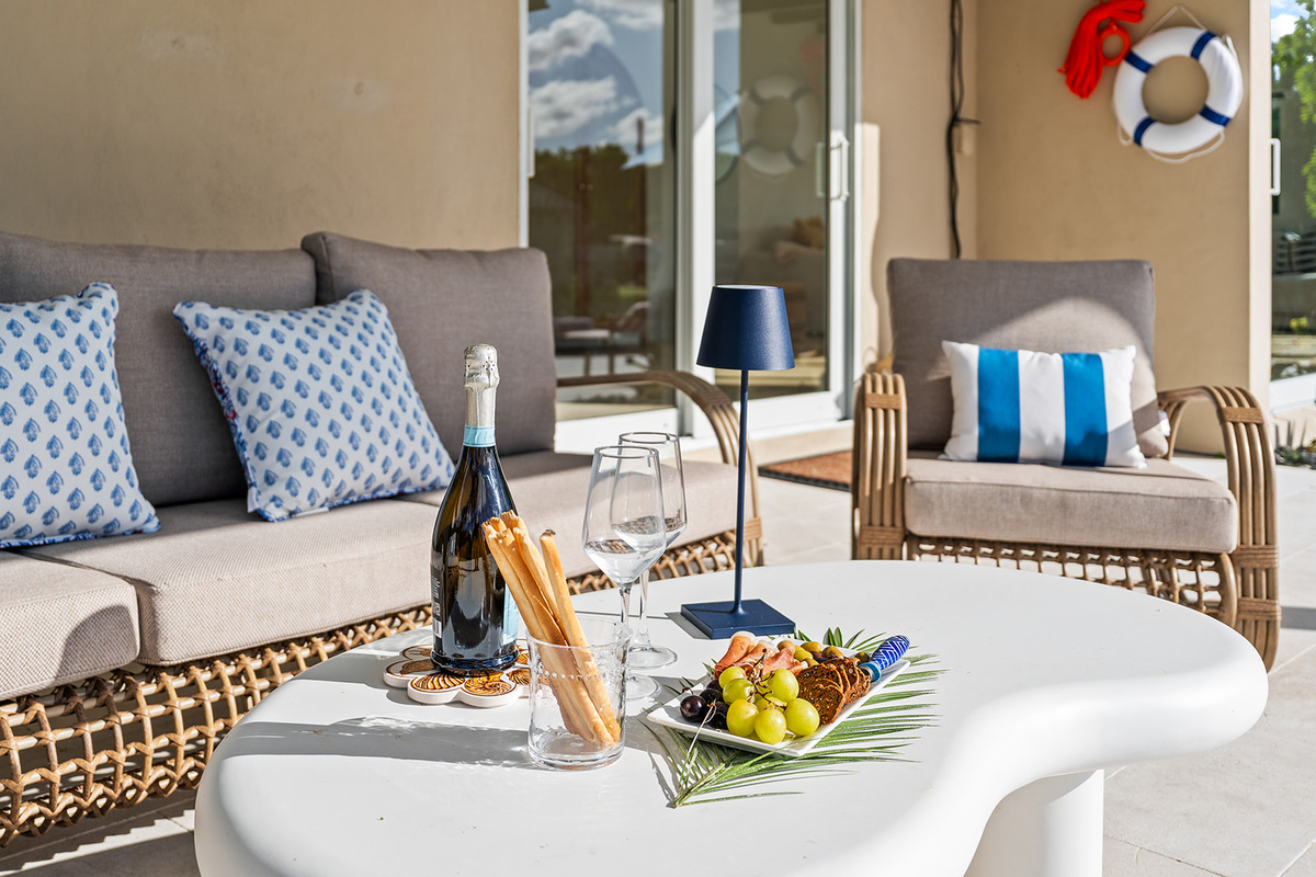 Enjoy relaxed waterfront living with cozy seating and the perfect setup for a sunset toast or casual gathering.