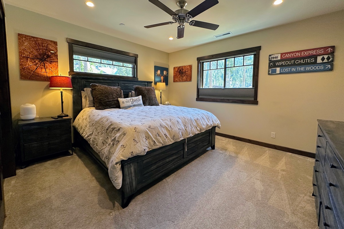 Spacious, sunny, and full of personality—the second primary bedroom features a comfy king bed, en-suite bath, smart TV, and big windows framing gorgeous views of Canyon Lodge. A little fun, a lot of comfort.