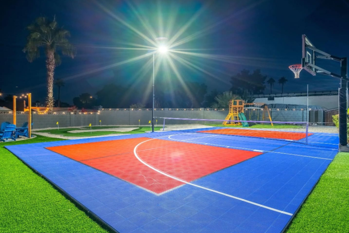 Full-size basketball and pickleball court, lit up and ready whenever the group wants to run it back.