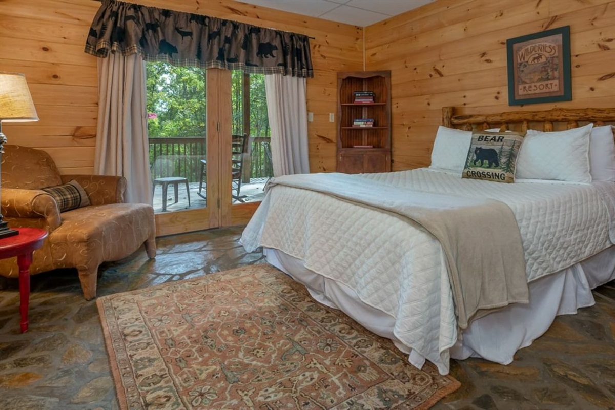 Master bedroom 3 on lower level - with full bath and French Doors to lower deck, with seating, overlooking back yard with lighted pavilion