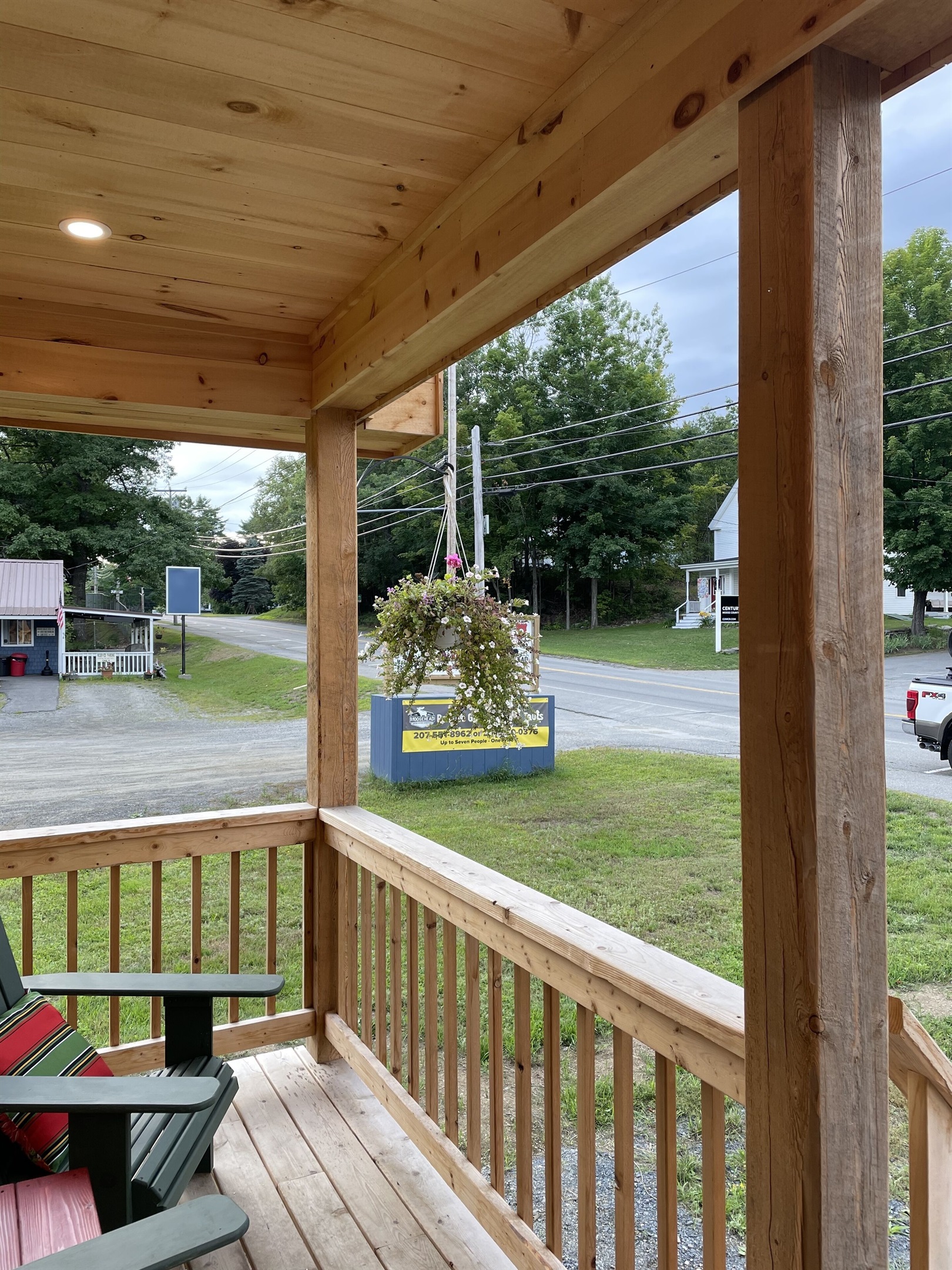 Front porch with Adirondack chairs with access to restaurants, shops, and lake!