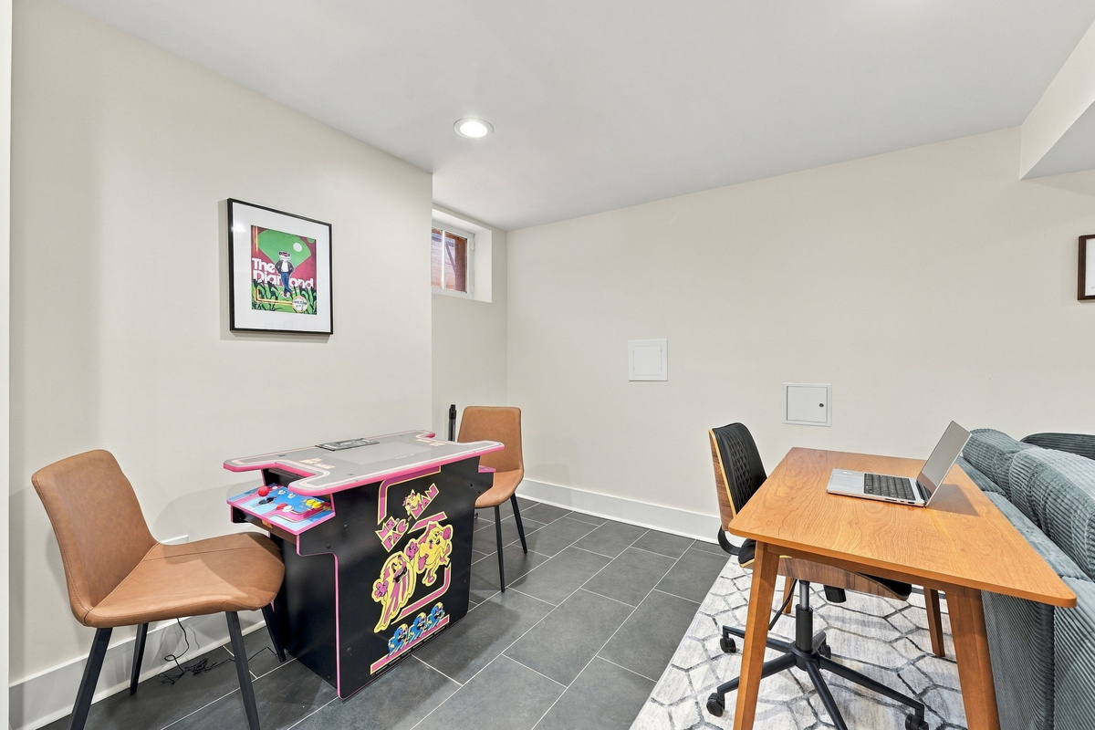 Game Room: Challenge friends at the arcade table while enjoying a stylish, sleek workspace!