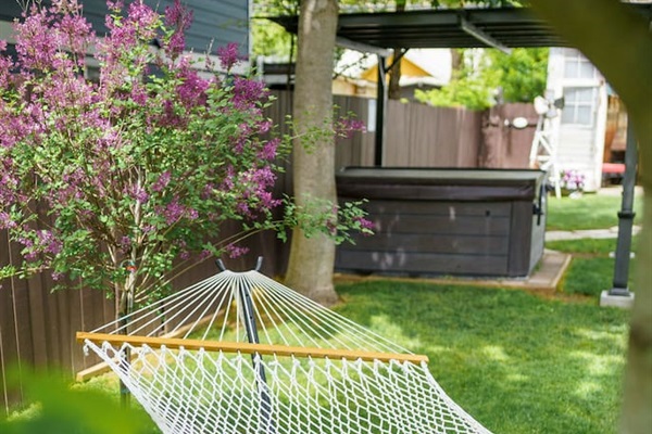Find your peace under the leaves. Enjoy a quiet moment in your shaded hammock, nestled beneath a large leafy maple.