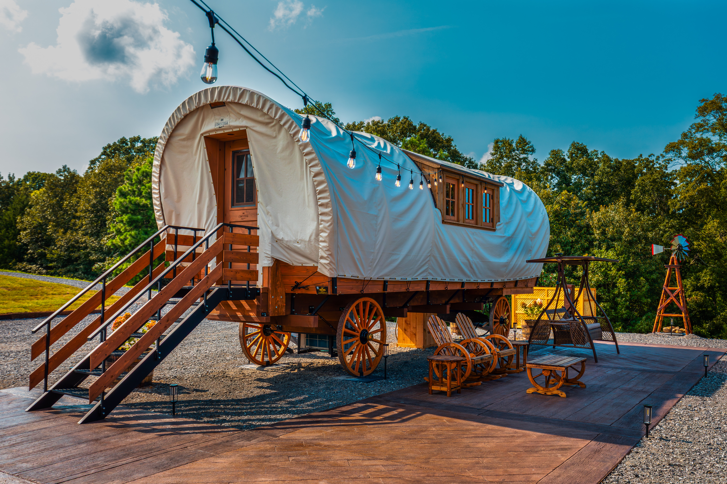 Classic covered wagon charm with private patio seating, wooded surroundings, and western details.