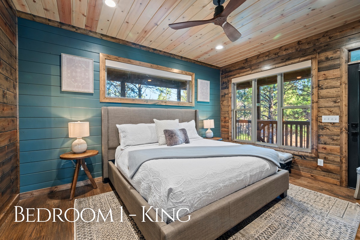 This king bedroom feels calm and cozy, with rustic wood walls, soft bedding, and a peaceful vibe that makes sleep come easy.