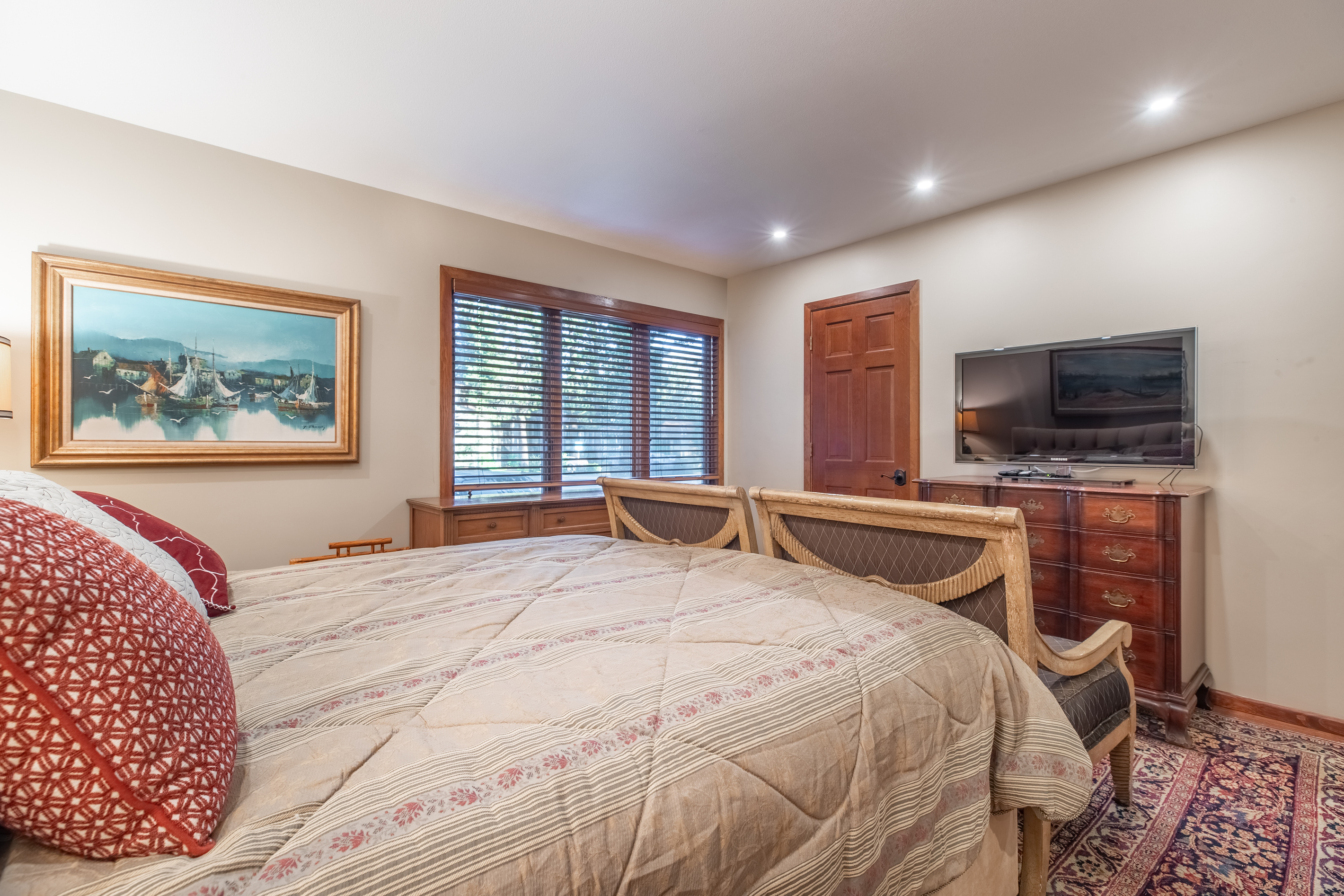 Master bedroom with warm furnishings and plenty of space