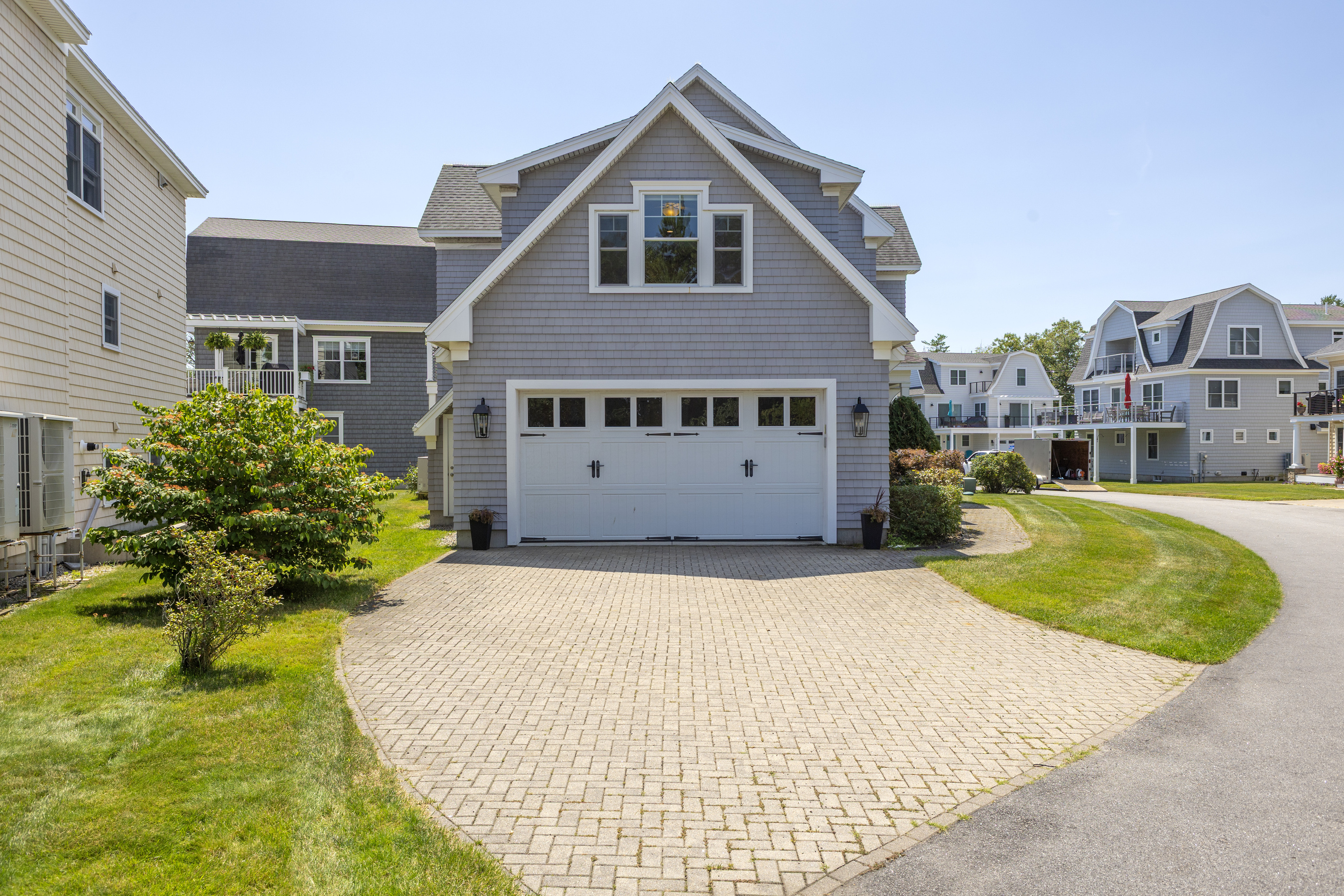 A welcoming coastal home with a private driveway and convenient garage access.
