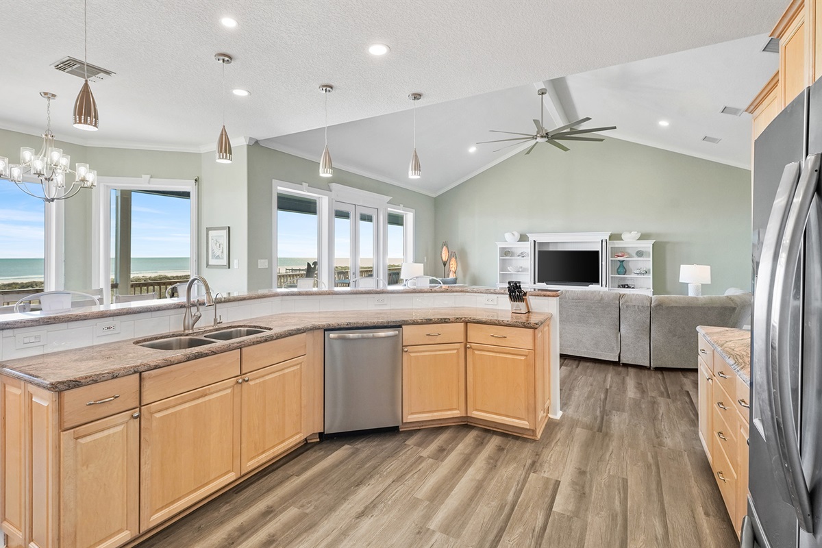 Beautiful wood cabinetry and a spacious kitchen island with seating for casual dining or keeping the chef company.