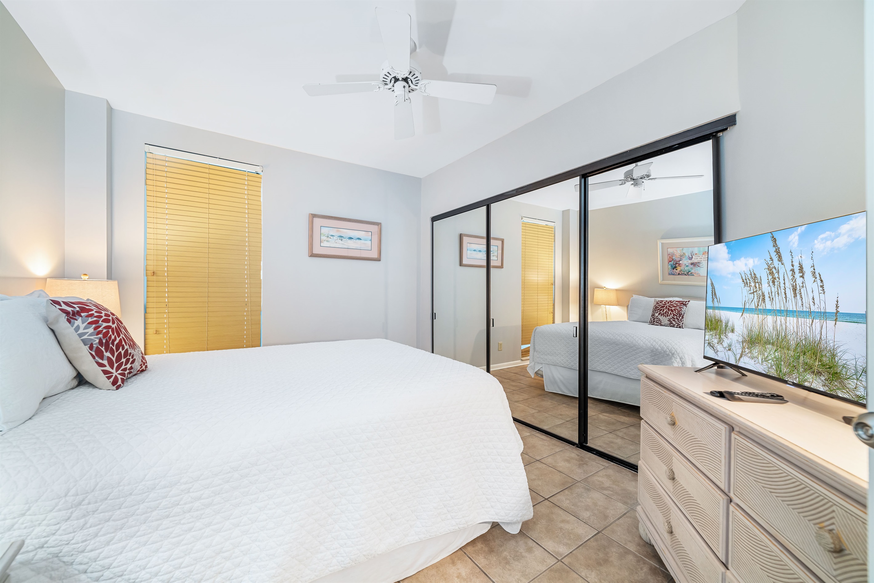 Bright and inviting guest bedroom featuring a comfortable queen-sized bed with ample storage. A perfect space to relax and recharge.