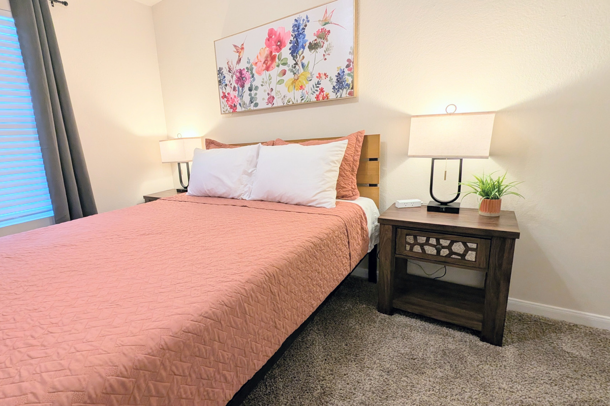 Comfort meets convenience in this peaceful queen bedroom, designed for a great night's rest.