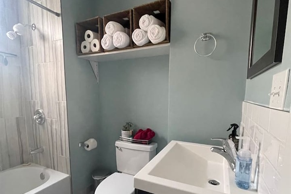 Bright bathroom stocked with fresh towels and guest essentials.