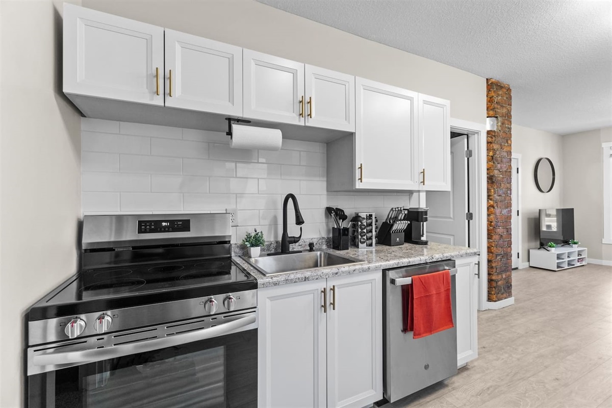 A fully equipped kitchen with brand-new cabinetry, stylish countertops, and state-of-the-art appliances.