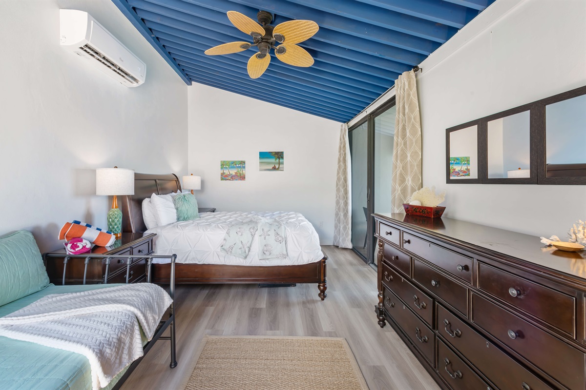 Charming second bedroom with queen and twin beds; perfect for family or friends.