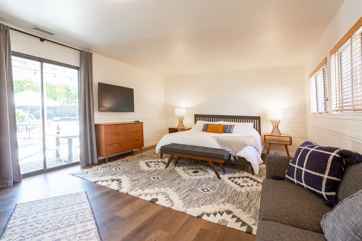 Comfortable king bed in primary room with a walk-in closet, ensuite bathroom, writing desk, flat screen TV and fold down couch. You'll have plenty of room to spread out and relax.